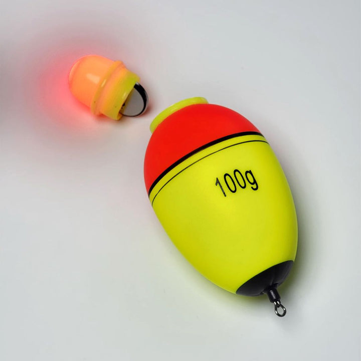 Bright yellow and red luminous fishing float with removable light attachment.