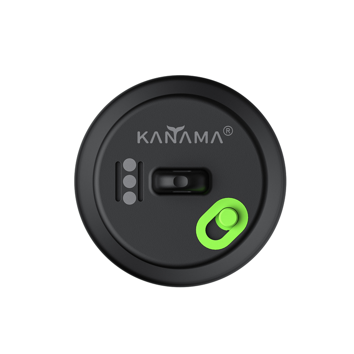 The image shows a dark-colored, circular device with the Kanama brand logo prominently displayed. The device has several controls or buttons, including a green accent button in the center. 