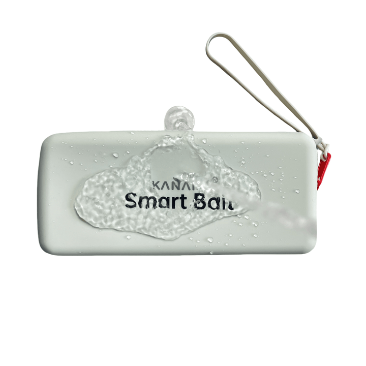 A white rectangular container with the words "Smart Bait" labeled on it and the brand name "KANAMA" printed on it. There are a few water drops above the box.