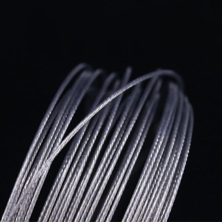 The image shows a close-up view of several strands of silver fishing wire or leader material.